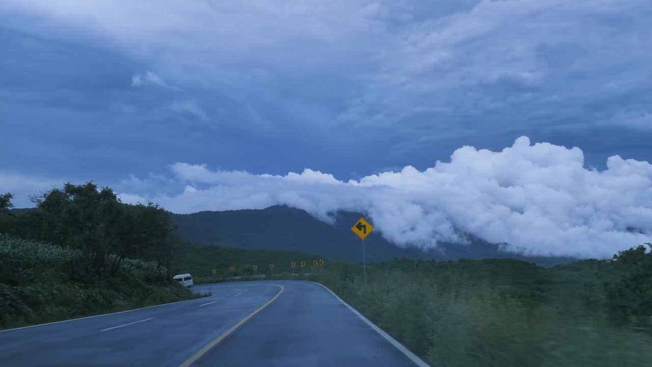 going_down_a_curved_highway_through_a_mountain_range