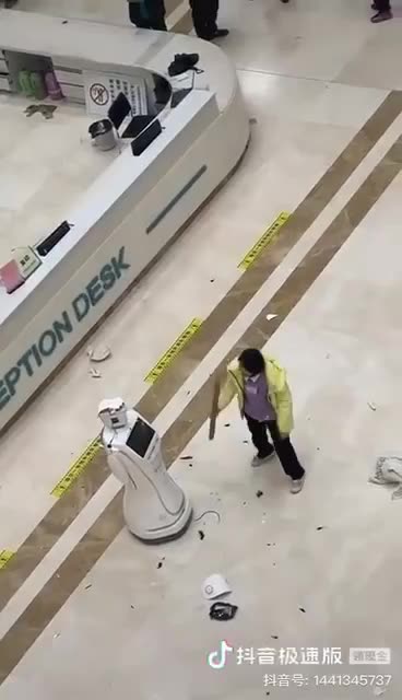 U Robot U - Woman beats down robot in China..