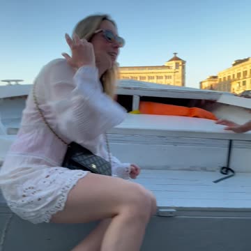 boat sails under a low bridge