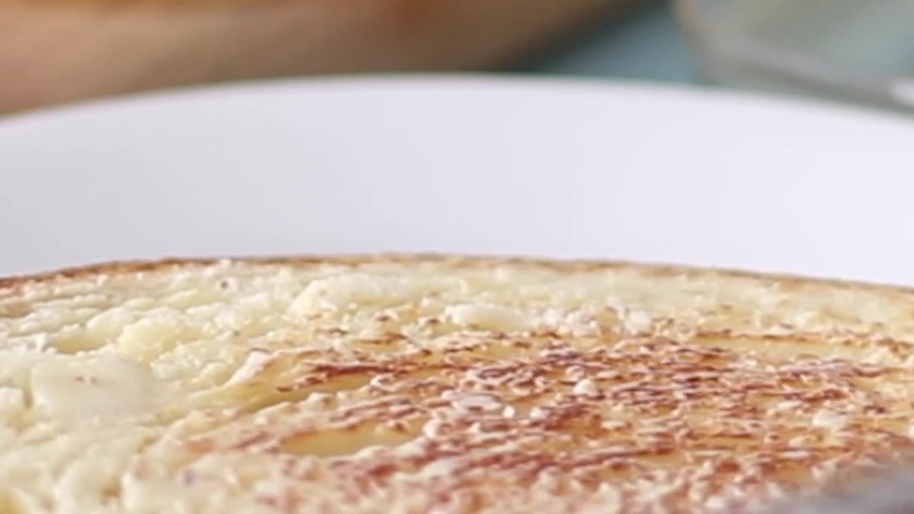 Spreading butter on toasted brioche