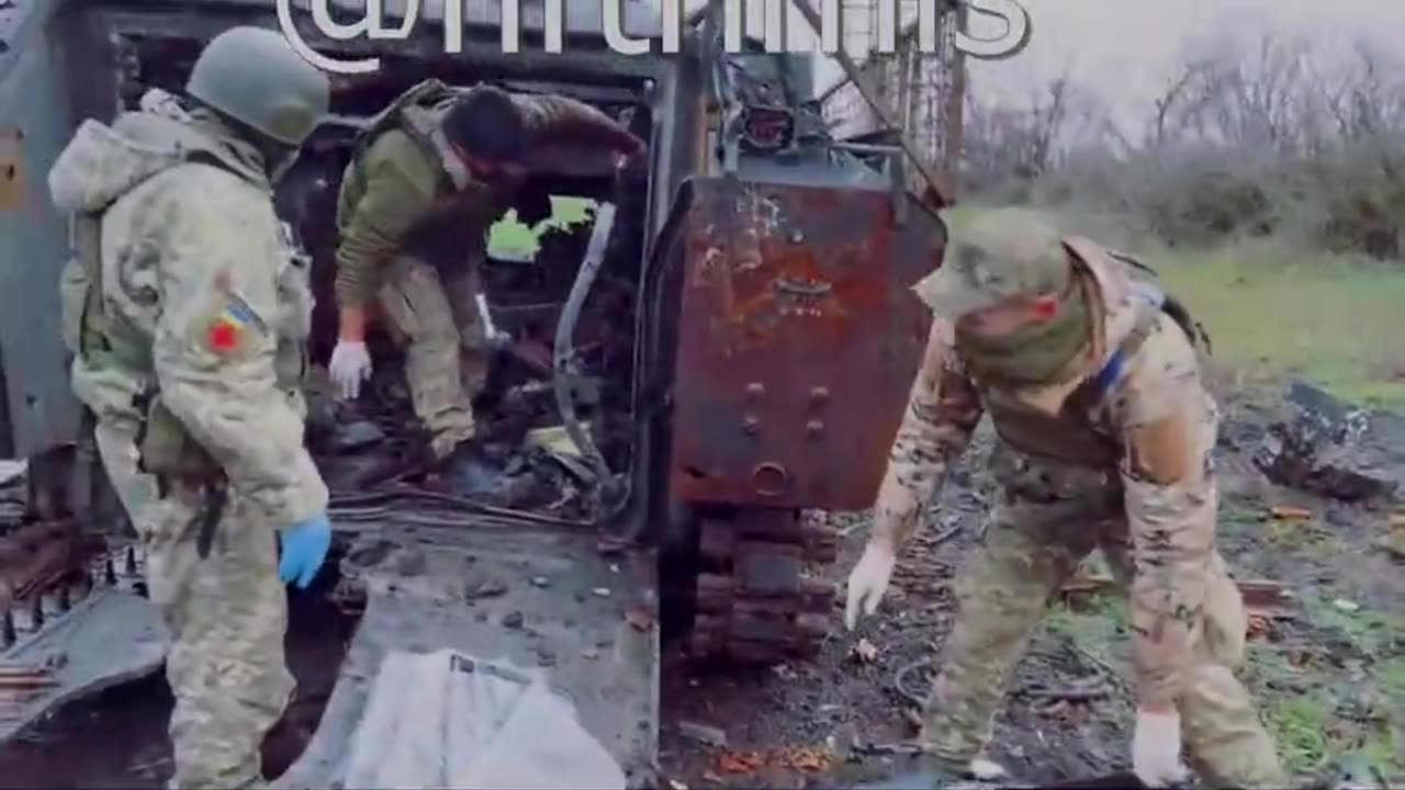 russian pulling bodies out of an apc GRAPHIC