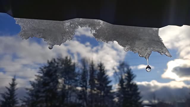 Snow melts from the roof. Nature of Russia.