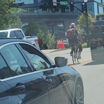 Crazy biker hitches a ride from back of truck
