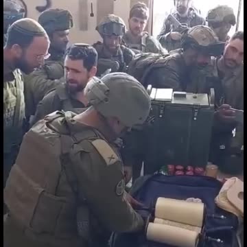 IDF Soldiers on break during a mission reading the Torah in Gaza