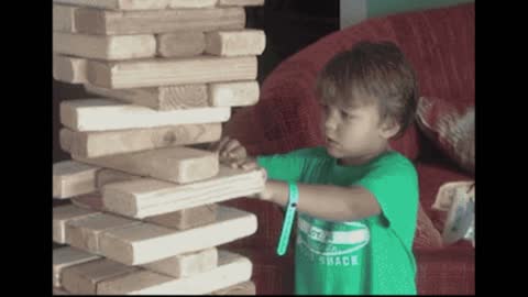 Gif video of boy building wooden tower