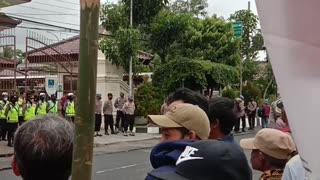 Indonesian police guard the demonstrators