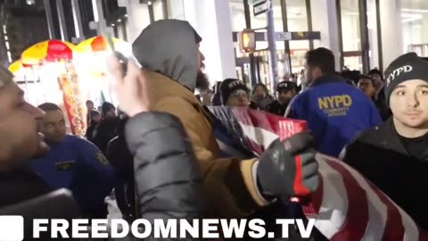 A patriot shows up to the NYC Christmas lighting ceremony with an American flag