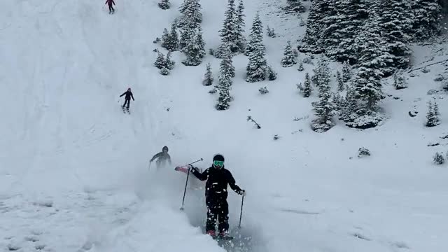 Skiers Skim Across Frozen Pond