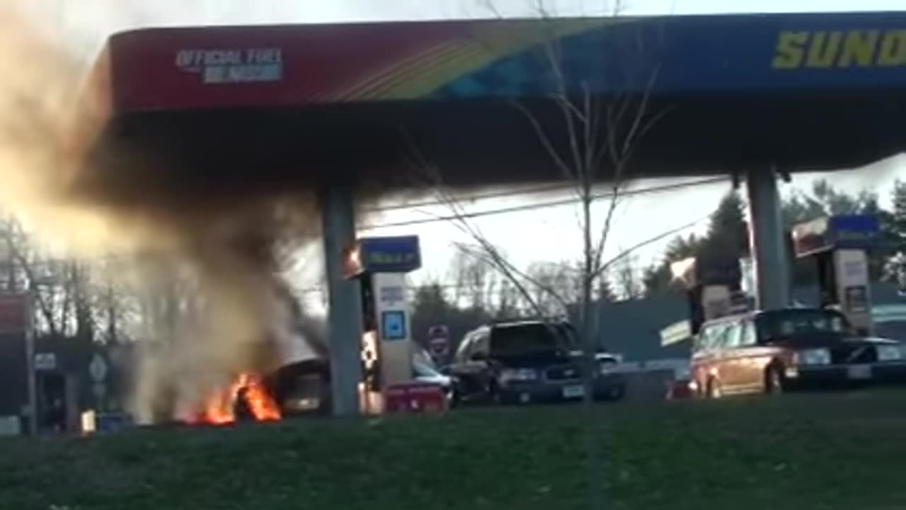 Car burning up at gas station small explosions