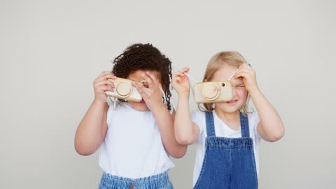 Two Young Girls Playing As Photographers