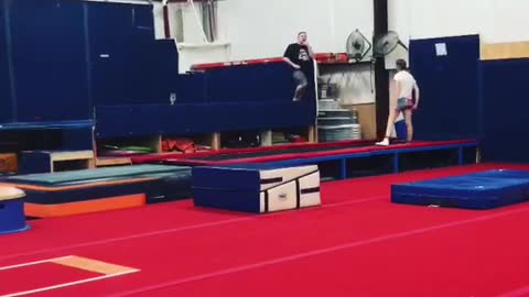 Girl in black shirt doing flip falls down