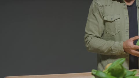 Portrait Shot of Man Picking up Broccoli with Copy Space