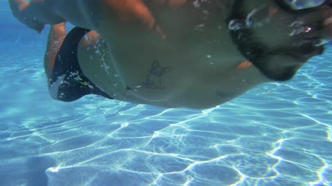 Swimming underwater in a pool