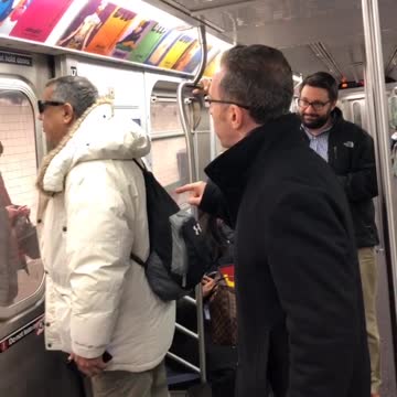 Two men argue about playing music without headphones on subway train