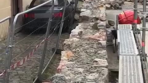 Car Squeezes Past Construction Fence