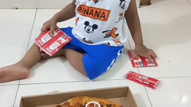 Baby seeing pizza for first time in his life
