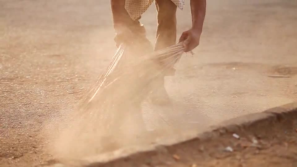 Person Sweeping the Floor Using Brooms