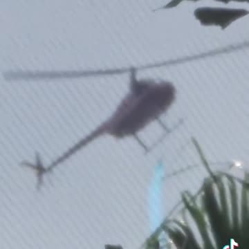 Helicopter spraying a mysterious blue chemical