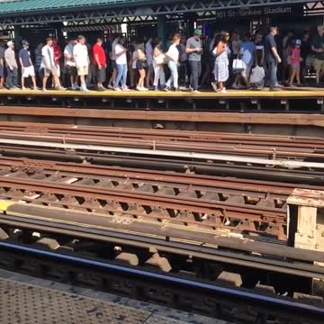 Long line of people at station next to yankee stadium