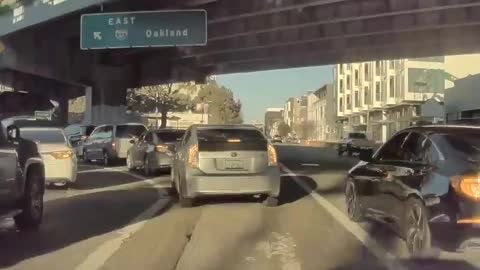 Caught in San Francisco on dash cam. Daylight freeway robbery.
