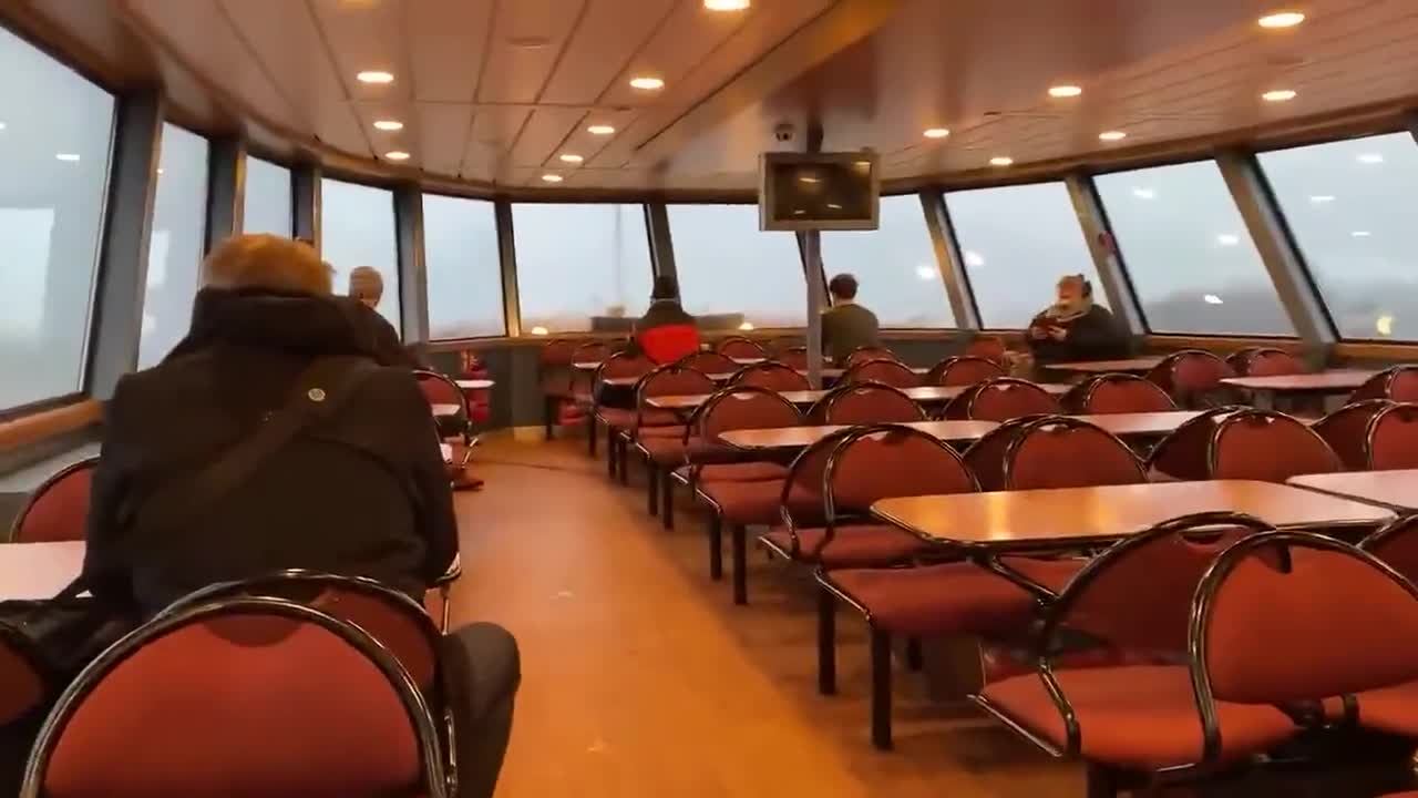 Water crashes through the front windows of a ferry