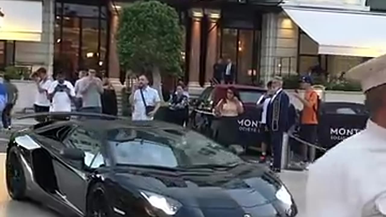 Billionaire lady boss getting out of Lamborghini SV