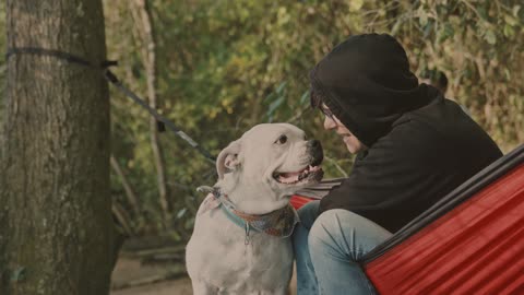 A Man with a White Dog Making Love In A Park