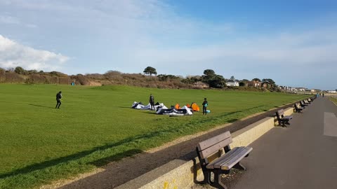 Kite surfers on a field. Getting ready to go in the sea