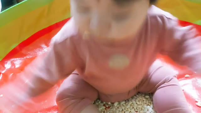 a cute baby eating rice snacks