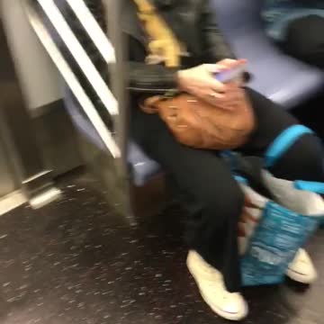 Woman subway yellow reptile lizard in black leather jacket