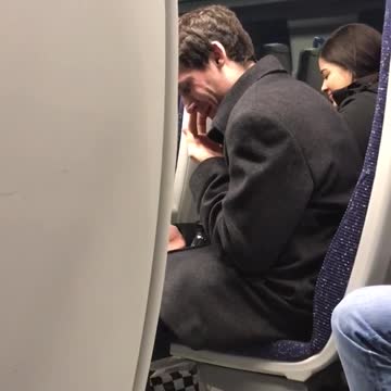 Man black sweater picking nose on train secretly