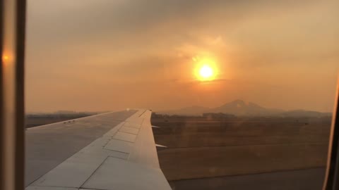 the view outside the window of a dusk plane