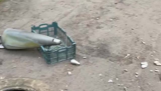 Ukraine War - A Donetsk woman shows the remains of a MLRS shell