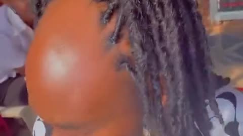 Lady uses her client’s unique hairstyle to encourage people in his class