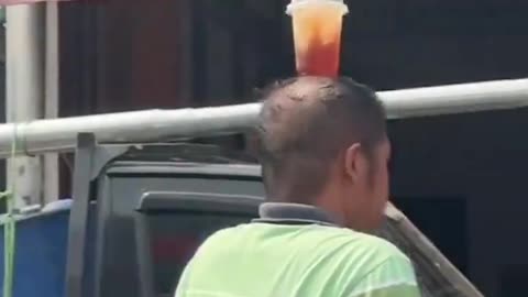 skill a man put ice on the head while riding a motorbike