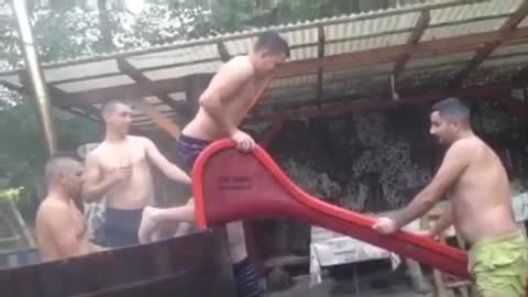 Guy goes down red slide face first into grass