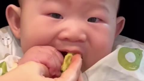 Hungry toddler sticks entire head in food bowl