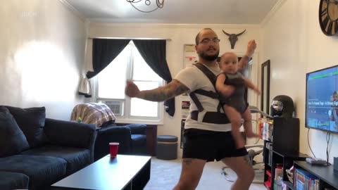 Dad Dances While Wearing Baby in Carrier