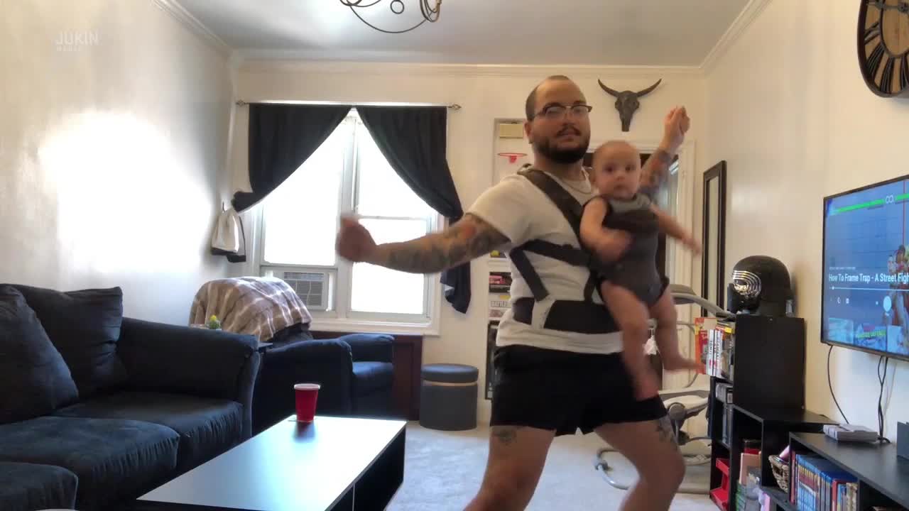 Dad Dances While Wearing Baby in Carrier