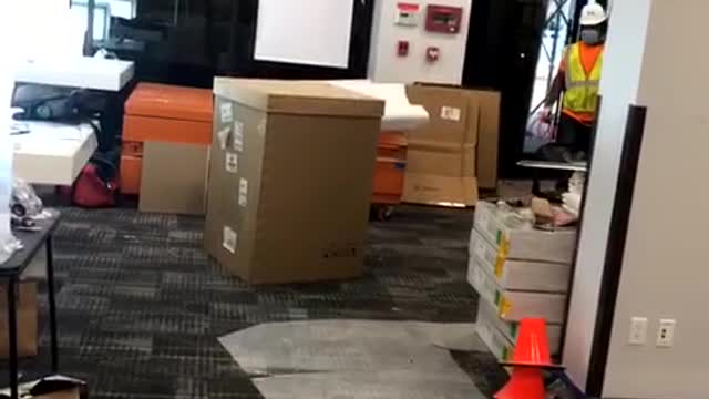 Man in Box Startles Workers and Pedestrians