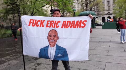 Activists has a flag that says " FUCK ERIC ADAMS "