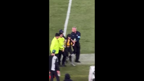 Woman Crashes Steelers Field Waving Secure Border Sign As Trump Looks On.