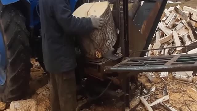 Hydraulic wood splitter harvesting firewood for the winter