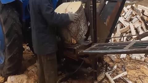 Hydraulic wood splitter harvesting firewood for the winter