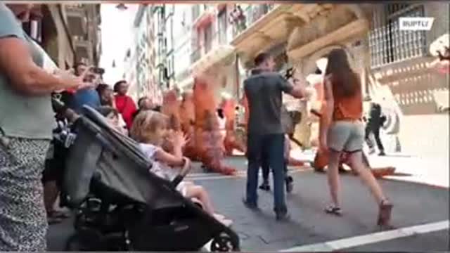 Animal rights activists play dinosaurs to protest Spain's running of the bulls festival