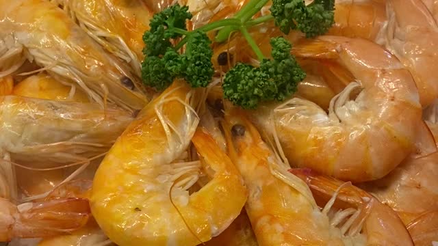 Delicious grilled shrimp is being cooked on the fire.