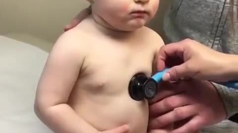 Cute boy rests head on nurses hand