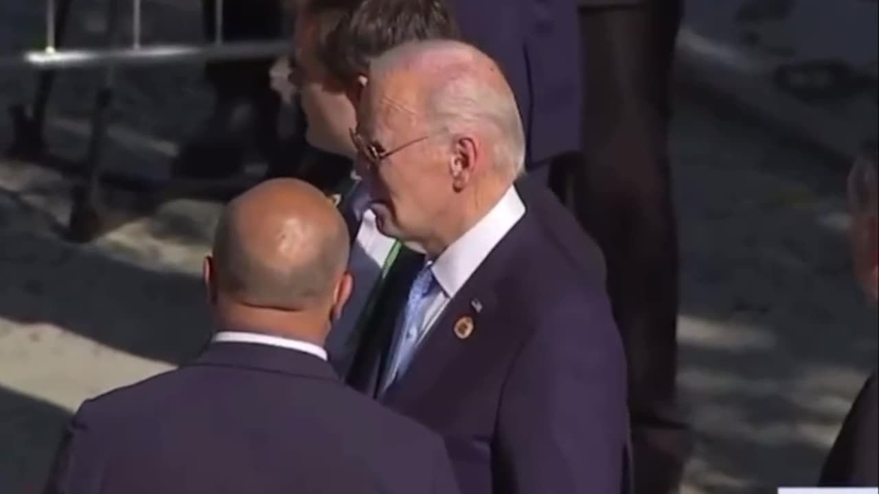 Joe Biden wandering around misses group photo