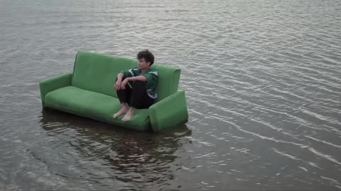 MAN ON THE COUCH IN THE WATER