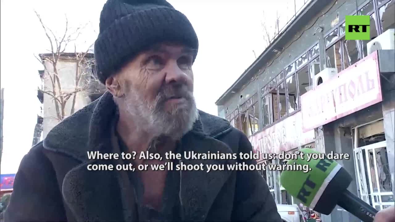 Senior Mariupol citizen crawls away from the Azov nationalists territory